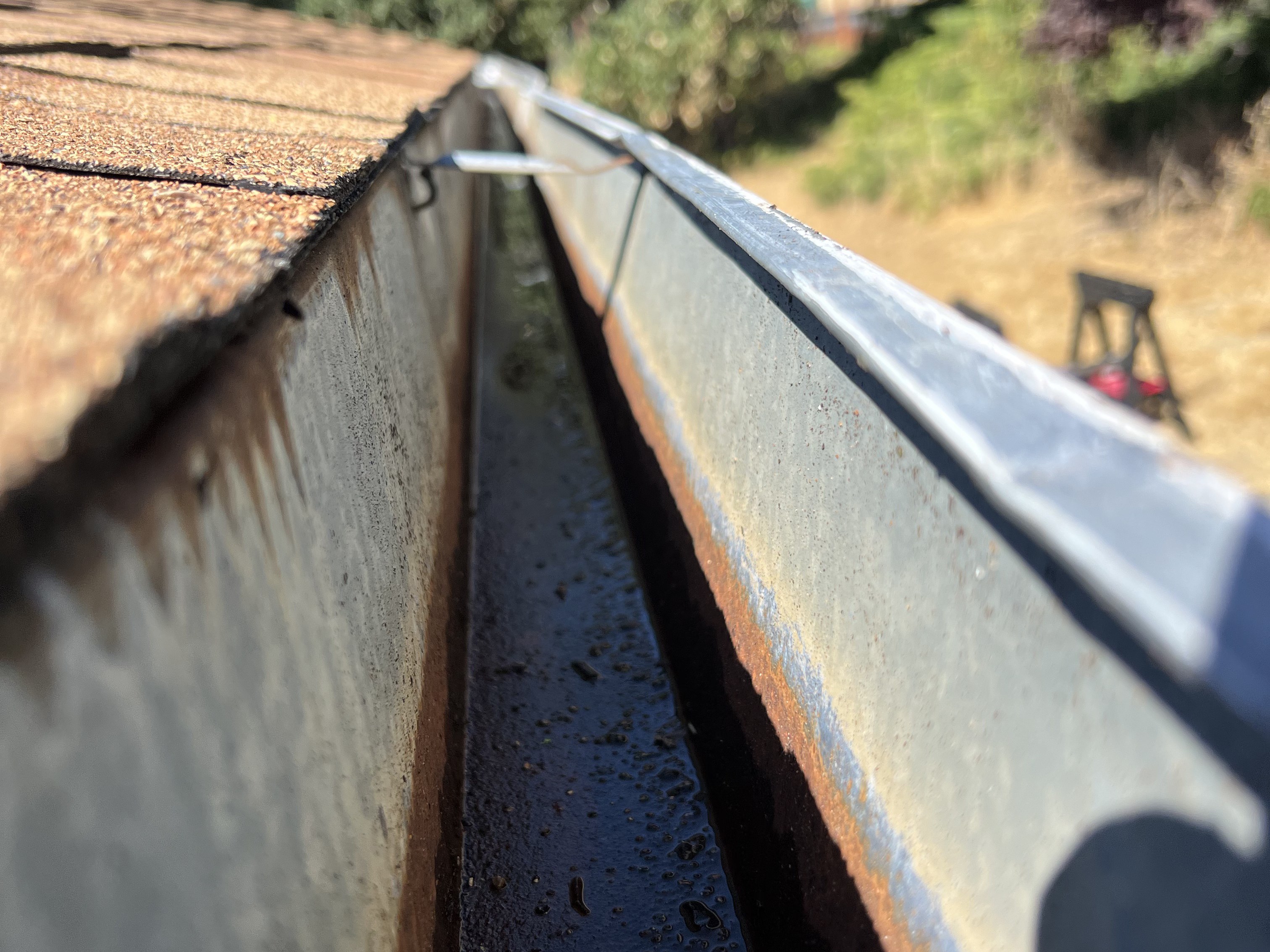 Cleaned-out metal gutter after a gutter cleaning by Wacky Weedeating in Tuolumne County