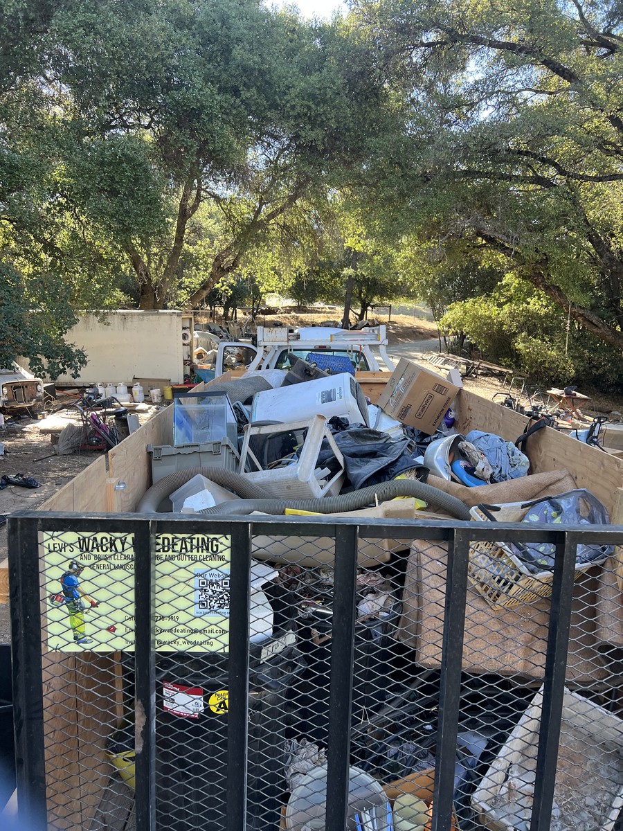 Trailer loaded with household items for junk removal by Wacky Weedeating in Tuolumne County