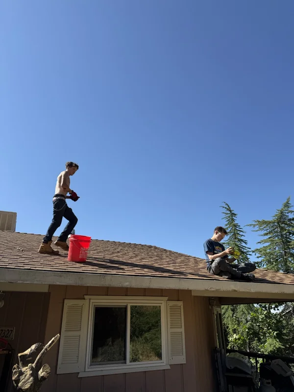 Crew cleaning roof gutters