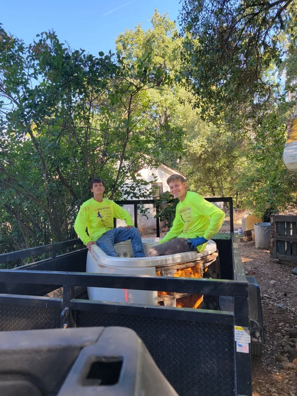 Crew removing an old bathtub
