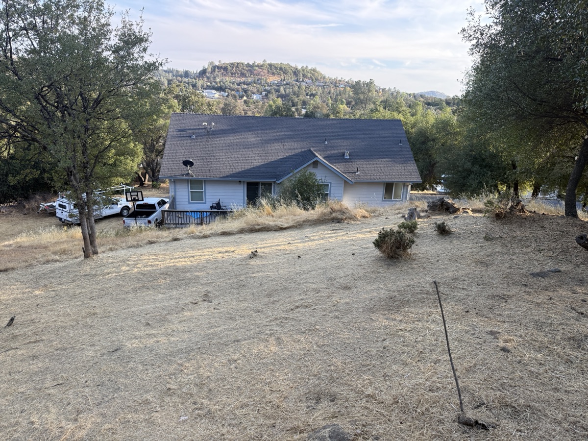 Hillside defensible space clearing around a home by Wacky Weedeating